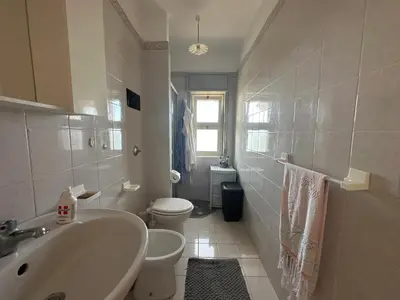 a white bathroom with a sink and a toilet at Villa Belvedere in Partinico