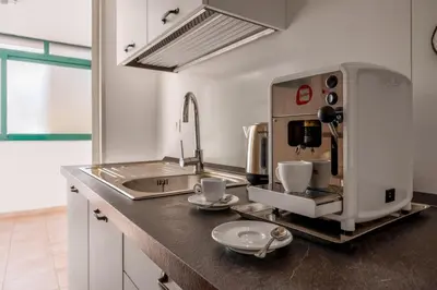 a kitchen with a coffee machine on a counter at Cortile Benso Guest House in Palermo