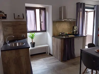 a kitchen with a sink and a counter top at Demasiantval house in Palermo
