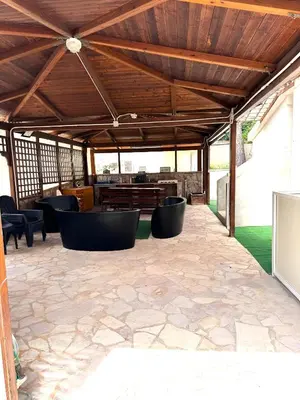 a covered patio with chairs and a table at Casa Giulù in Palermo