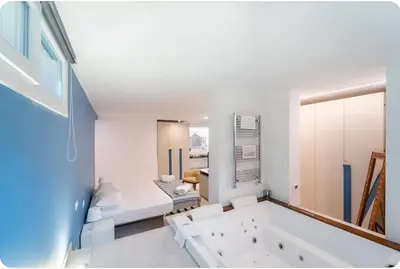 a large white bathroom with a tub in it at Casa Giulù in Palermo