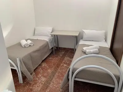 a bedroom with a bed and a large window at panorama home central in Palermo