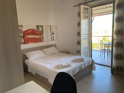 a city with buildings and mountains in the background at panorama home central in Palermo
