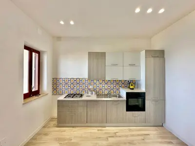 a kitchen with a sink and a stove at Riva Marina, sulla spiaggia in Alcamo