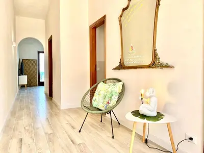 a room with a chair and a mirror on the wall at Riva Marina, sulla spiaggia in Alcamo
