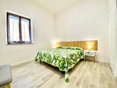 a bedroom with a bed and a desk and a window at Riva Marina, sulla spiaggia in Alcamo