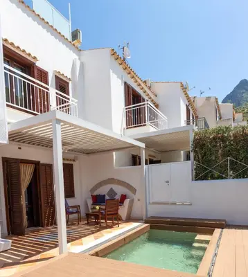a villa with a swimming pool and a house at Anemos Apartment - Villa Sole in Macari