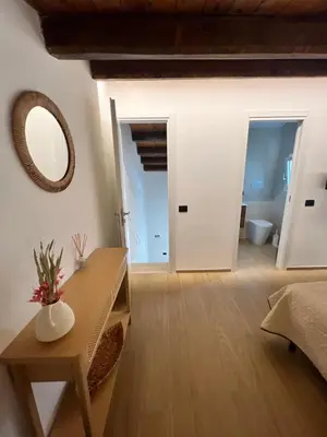 a living room with a mirror and a table and a bed at Villa Clori in Trabia