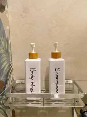 two bottles ofodorizers sitting on a glass shelf at Villa Clori in Trabia