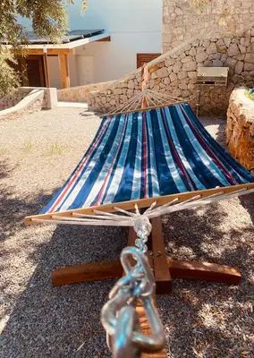 a hammock sitting in a yard with a chain at Villa Clori in Trabia