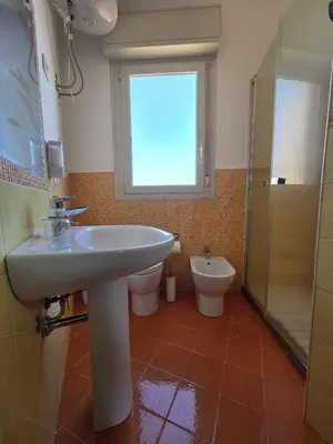 a bathroom with a sink and a toilet and a window at I Vicini di Ballarò in Palermo