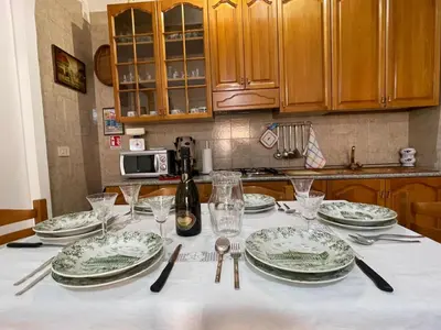 a table with plates and wine glasses on it at Casa MIUZZA in Isola delle Femmine