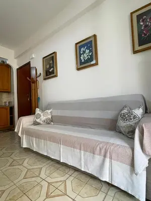 a room with a bed with two pillows on it at Casa MIUZZA in Isola delle Femmine
