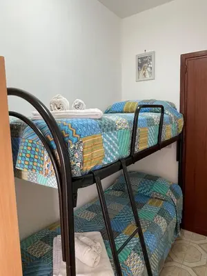 a bedroom with two bunk beds in a room at Casa MIUZZA in Isola delle Femmine