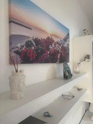 a white shelf with a picture of flowers on it at Casa MIUZZA in Isola delle Femmine