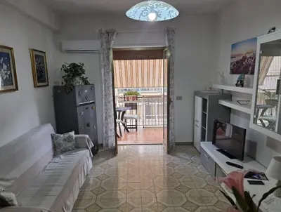 a living room with a couch and a fireplace at Casa MIUZZA in Isola delle Femmine