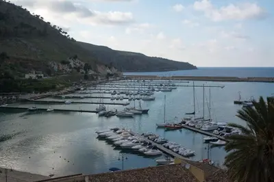 a bunch of boats are docked in a harbor at Casa De Gasperi in Castellammare del Golfo