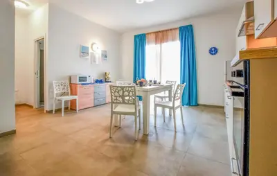 a kitchen and dining room with a table and chairs at Beautiful Apartment In Balestrate in Balestrate