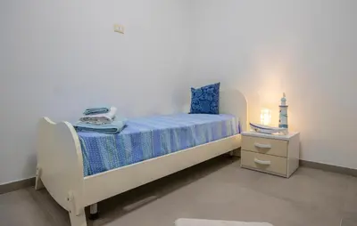 a small bedroom with a bed and a night stand at Beautiful Apartment In Balestrate in Balestrate