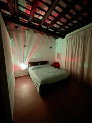 a bedroom with a bed with a light on it at Loft Al Baglio del Gelso in Balestrate
