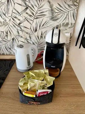 a coffee maker sitting on a table next to a coffee pot at Loft Al Baglio del Gelso in Balestrate