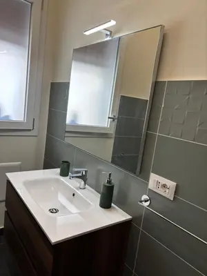 a bathroom with a sink and a mirror at Giulia's Apartment in Altavilla Milicia