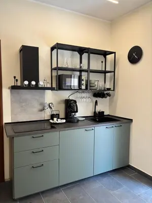 a kitchen with blue cabinets and a counter top at Giulia's Apartment in Altavilla Milicia