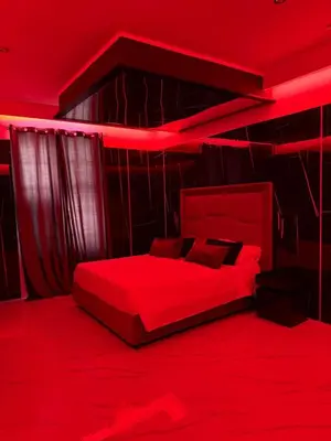 a red bedroom with a bed with red lighting at Luxurymimi in Palermo