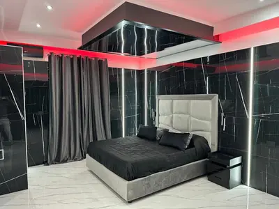 a bedroom with a bed with a black wall at Luxurymimi in Palermo