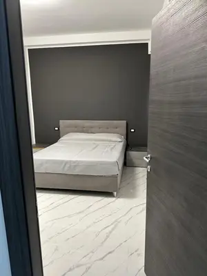 a bedroom with a bed and a door open at Luxurymimi in Palermo