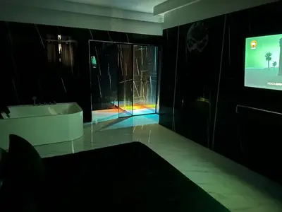 a bathroom with a tv and a tub and a sink at Luxurymimi in Palermo