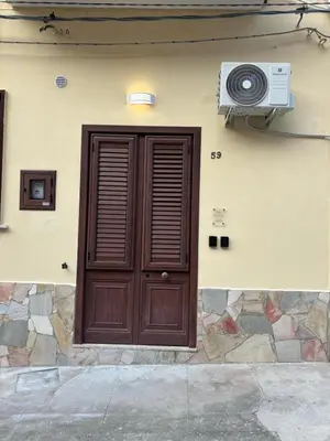 a house with a door and a television on the side at Helios Apartaments in Cinisi