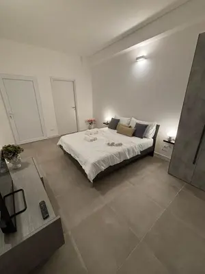 a bedroom with a large bed in a room at Helios Apartaments in Cinisi
