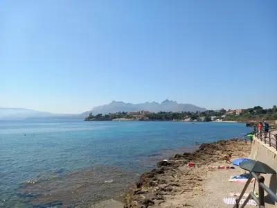 a group of people on a beach near the water at Giomasue' in Porticello