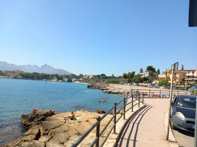 a beach with a car parked next to the water at Giomasue' in Porticello