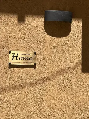 a home sign on the side of a wall at Infiniti noi home in Palermo