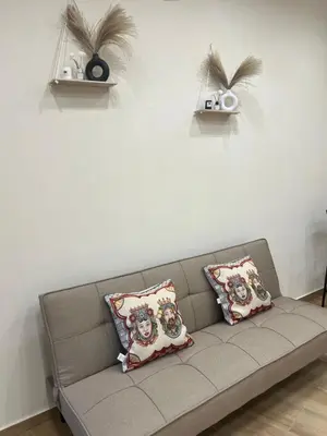 a couch with pillows on it in a living room at Infiniti noi home in Palermo