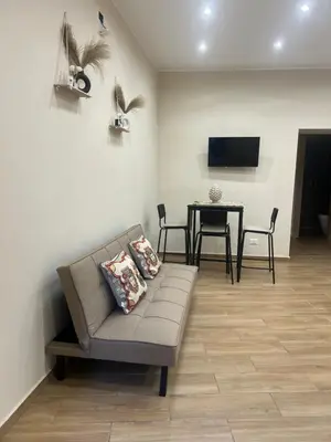 a living room with a couch and a table at Infiniti noi home in Palermo