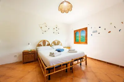 a bedroom with a large bed in a room at Villa Casty with private pool in Trabia