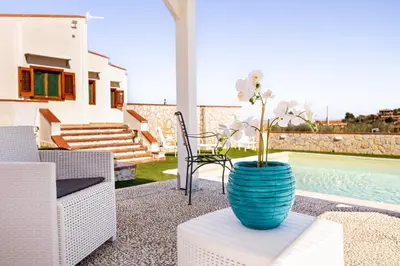 a blue vase sitting on a table next to a pool at Villa Casty with private pool in Trabia