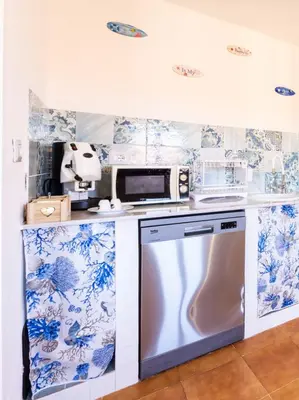 a kitchen with blue and white wallpaper at Villa Casty with private pool in Trabia