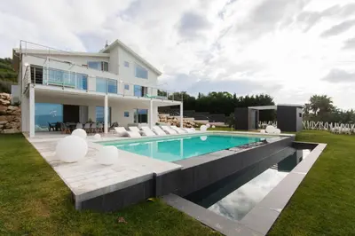a villa with a swimming pool and a house at White Luxury Villa by Le Dhome Sicily in Partinico