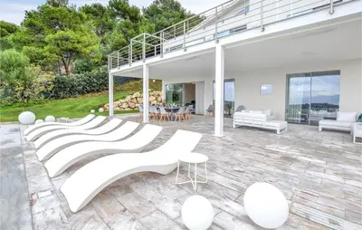 a house with white chairs and a living room at White Luxury Villa by Le Dhome Sicily in Partinico