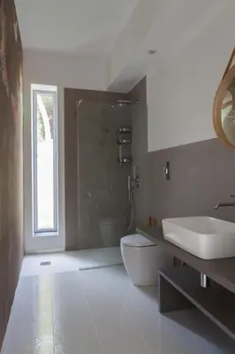 a bathroom with a sink and a toilet and a window at White Luxury Villa by Le Dhome Sicily in Partinico