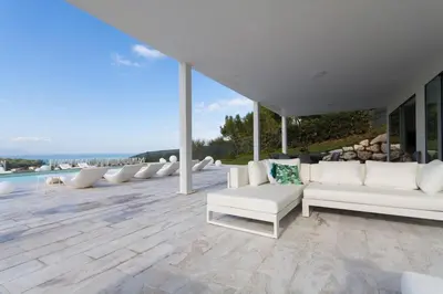 a living room with white couches and a pool at White Luxury Villa by Le Dhome Sicily in Partinico