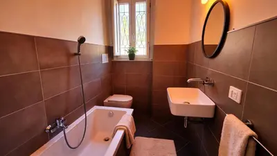 a bathroom with a sink and a toilet and a tub at Via del Bastione in Palermo