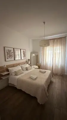 a bedroom with a large bed with two towels on it at Mahalo in Palermo
