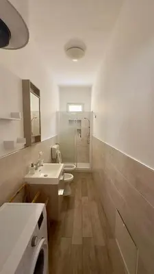 a bathroom with a toilet and a sink and a shower at Mahalo in Palermo