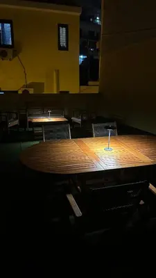 a long wooden table in a room with chairs at Mahalo in Palermo