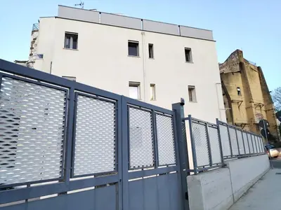 a black fence in front of a white building at QASA apartment with terrace, Palermo center in Palermo